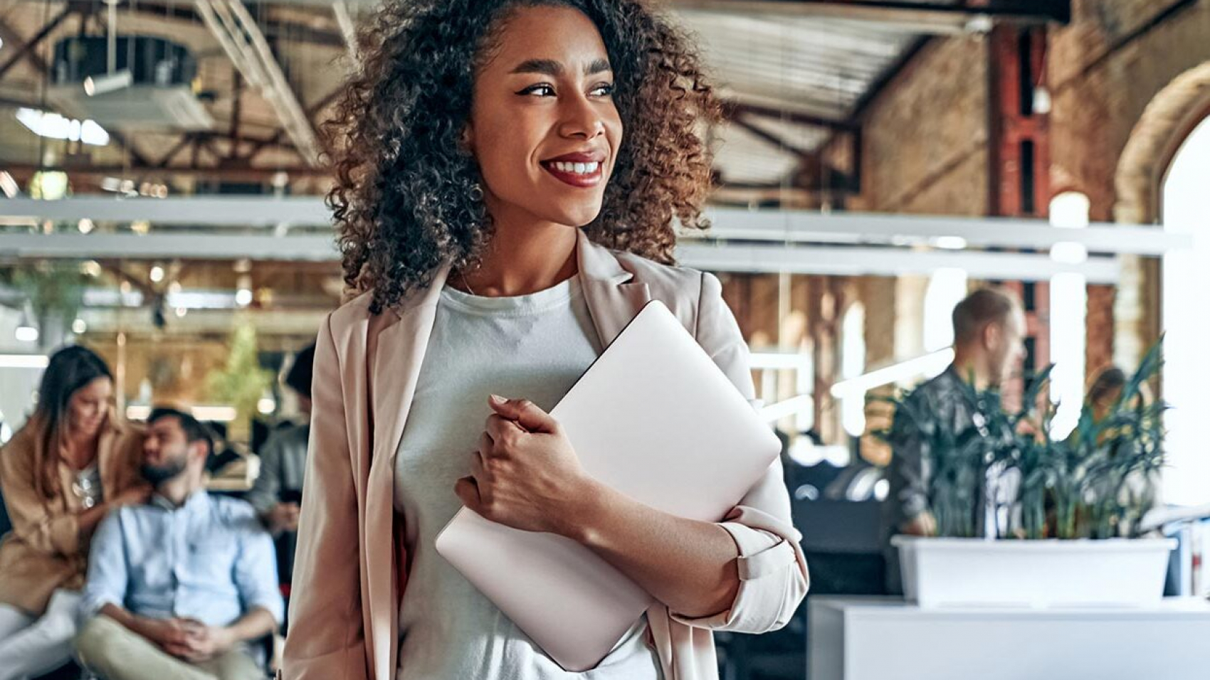 a woman holding a laptop