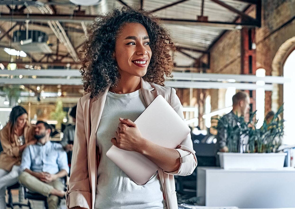 a woman holding a laptop