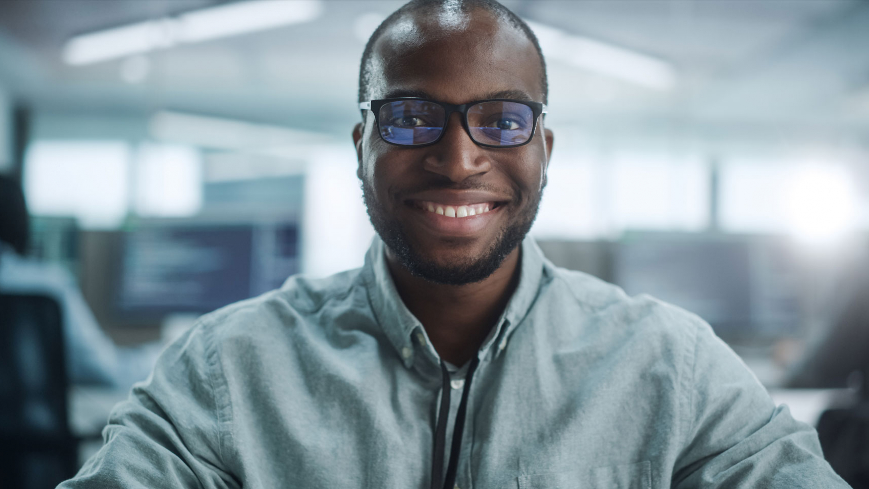 a man wearing glasses smiling