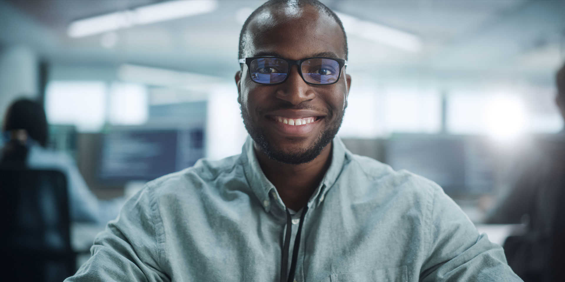 a man wearing glasses smiling