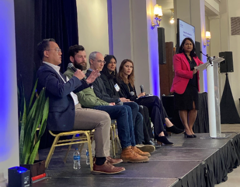 Panel of speakers on a stage